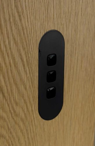 ZETR-Three-gang-switch-in-matte-black-on-NAV-Text-Oak-Finish-327x500